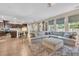 Spacious living room with an open concept, comfortable seating, a kitchen island, and plenty of natural light at 9829 English Elm St, Ladson, SC 29456