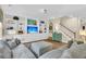 Open living room featuring built-in shelving, comfortable seating, and a staircase to the upper level at 9829 English Elm St, Ladson, SC 29456