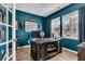 Home office featuring a solid wood desk, ample natural light, and an accent wall at 9829 English Elm St, Ladson, SC 29456