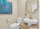 Chic powder room featuring vanity sink with gold faucet, decorated mirror and modern toilet at 9829 English Elm St, Ladson, SC 29456