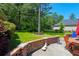 Lush green backyard featuring a brick patio with outdoor seating and mature trees, perfect for relaxation at 101 Firestone Ct, Summerville, SC 29483