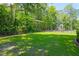 Large, fenced backyard with a lush lawn and mature trees, perfect for outdoor activities and relaxation at 101 Firestone Ct, Summerville, SC 29483