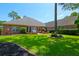 Beautiful backyard with a lush green lawn, brick accents, and mature trees surrounding the property at 101 Firestone Ct, Summerville, SC 29483