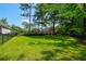The fenced backyard features a lush lawn, mature trees, and well-maintained landscaping at 101 Firestone Ct, Summerville, SC 29483