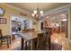Dining room with wooden table set situated adjacent to the bright and airy sunroom at 101 Firestone Ct, Summerville, SC 29483