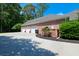 Three-car garage with brick exterior and mature landscaping for added curb appeal and functionality at 101 Firestone Ct, Summerville, SC 29483