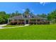 Traditional home featuring a covered porch, manicured landscaping, lush green lawn, and beautiful trees at 101 Firestone Ct, Summerville, SC 29483