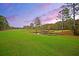 Scenic view of the golf course featuring lush green fairways, a pond, and trees in the background at 101 Firestone Ct, Summerville, SC 29483