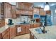 Warm kitchen features custom wood cabinetry, granite counters, stainless appliances, and center island sink at 101 Firestone Ct, Summerville, SC 29483