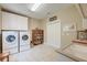 Laundry room features white appliances, cabinets, and a sink, offering a functional space for everyday tasks at 101 Firestone Ct, Summerville, SC 29483