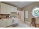 A convenient laundry room with ample cabinetry and a unique circular window for natural light at 101 Firestone Ct, Summerville, SC 29483