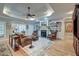 Comfortable living room boasts hardwood floors, fireplace, built-in bookshelves, and tray ceiling with fan at 101 Firestone Ct, Summerville, SC 29483