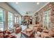 Bright sunroom with brick walls, ceiling fan, an abundance of natural light, and comfortable seating at 101 Firestone Ct, Summerville, SC 29483