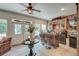 Stylish sunroom features brick accent walls, ceiling fan, an abundance of light, bar, and outdoor access at 101 Firestone Ct, Summerville, SC 29483