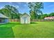 Backyard featuring a shed and carport, enclosed by a wood fence, providing ample storage and privacy at 101 Parkside Dr, Goose Creek, SC 29445