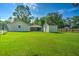 Expansive backyard with green lawn, storage shed, and garage providing ample outdoor space and storage at 101 Parkside Dr, Goose Creek, SC 29445