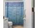 Bright bathroom with toilet, shower, vanity and cabinet, featuring a mosaic shower curtain at 101 Parkside Dr, Goose Creek, SC 29445
