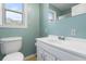 Well-lit bathroom featuring a white vanity, toilet, and a window with natural light at 101 Parkside Dr, Goose Creek, SC 29445