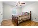 Cozy bedroom featuring warm hardwood floors, ceiling fan and comfortable quilt at 101 Parkside Dr, Goose Creek, SC 29445