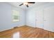 Bright bedroom with light blue walls, ceiling fan and gleaming hardwood floors at 101 Parkside Dr, Goose Creek, SC 29445