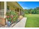 Charming single story brick home with a covered porch with decorative roses on the corner of the home at 101 Parkside Dr, Goose Creek, SC 29445