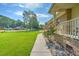 Beautiful brick home featuring a well-maintained lawn and charming front porch with rose bushes at 101 Parkside Dr, Goose Creek, SC 29445