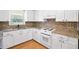 Well-lit kitchen with white cabinetry, stainless steel appliances, and granite countertops at 101 Parkside Dr, Goose Creek, SC 29445