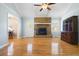 Bright living room with brick fireplace, hardwood floors, large window, and classic decor at 101 Parkside Dr, Goose Creek, SC 29445