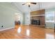 Cozy living room featuring hardwood floors, fireplace, natural light, and calming green walls at 101 Parkside Dr, Goose Creek, SC 29445