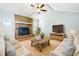 Comfortable living room features a brick fireplace, ceiling fan, and natural light for a cozy atmosphere at 101 Parkside Dr, Goose Creek, SC 29445