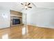 Spacious living room featuring a cozy fireplace, hardwood floors, natural light and brick surround at 101 Parkside Dr, Goose Creek, SC 29445
