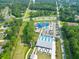 Aerial view showcases a waterpark with slides, pool, parking, and surrounding greenery at 101 Parkside Dr, Goose Creek, SC 29445