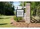 Community sign for Taylor Farms in a wooded area, with brick columns and a white fence at 1014 Peridote Way, Ladson, SC 29456