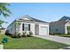 View of a one-story home featuring white siding, black shutters, green grass, and an attached one-car garage at 1014 Peridote Way, Ladson, SC 29456