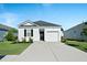 Charming one-story home featuring white siding, a black door, and an attached one-car garage with driveway at 1014 Peridote Way, Ladson, SC 29456