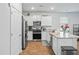 Well-lit kitchen featuring granite countertops, stainless steel appliances, and white cabinets at 1014 Peridote Way, Ladson, SC 29456