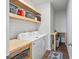 Functional laundry room includes a modern washer and dryer, shelving, and workspace at 1014 Peridote Way, Ladson, SC 29456