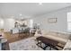 Open-concept living space with a modern sofa, decorative rug, and adjacent kitchen area at 1014 Peridote Way, Ladson, SC 29456