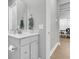 Clean bathroom features a toilet paper holder, clean countertop, framed mirror, and partial view to dining table at 1017 Marsh Royal St, Summerville, SC 29485