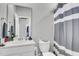 Clean bathroom featuring a white sink, light gray walls, and a striped shower curtain at 1017 Marsh Royal St, Summerville, SC 29485