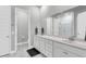 Bright bathroom featuring double vanity with white cabinets and countertop and a large mirror at 1017 Marsh Royal St, Summerville, SC 29485