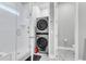 This bathroom features a shower and a toilet along with a stackable washer and dryer unit at 1017 Marsh Royal St, Summerville, SC 29485