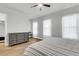 This bedroom features a ceiling fan, a dresser, a small desk, and three windows for natural light at 1017 Marsh Royal St, Summerville, SC 29485
