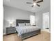 Comfortable bedroom featuring two nightstands, a ceiling fan, hardwood floors, and an en-suite bathroom for privacy at 1017 Marsh Royal St, Summerville, SC 29485