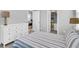 A furnished bedroom is shown with a closet, drawers, carpet and a comfy bed at 1017 Marsh Royal St, Summerville, SC 29485