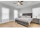 Calm bedroom with soft gray furnishings, two bedside tables and lamps, and natural light shining through the windows at 1017 Marsh Royal St, Summerville, SC 29485