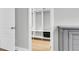 Open closet with custom shelves and a view into a bedroom that has light wood floors at 1017 Marsh Royal St, Summerville, SC 29485