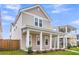 Charming two-story home featuring a welcoming front porch with stately white columns and a well-manicured lawn at 1017 Marsh Royal St, Summerville, SC 29485