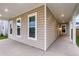 Exterior view of the home with a concrete patio and tan siding at 1017 Marsh Royal St, Summerville, SC 29485