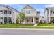 Charming two-story home featuring a welcoming front porch with stately white columns, lawn, and street view at 1017 Marsh Royal St, Summerville, SC 29485